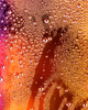 Joel Dixon, a graduate artist in the UK captures a close-up of condensation droplets on a glass surface, where vibrant orange and yellow lighting create an abstract pattern. This mesmerizing piece is part of the graduate artworks for sale by The Graduate Gallery.