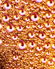 Joel Dixon, a graduate artist in the UK captures a close-up of condensation droplets on a glass surface, where vibrant orange and yellow lighting create an abstract pattern. This mesmerizing piece is part of the graduate artworks for sale by The Graduate Gallery.