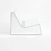 Discover a modern chair with a minimalist design, featuring a reflective mirror surface. Its angular shape creates a geometric aesthetic, set against a plain white background. This stunning piece of furniture is available for sale by The Graduate Gallery.