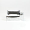 A modern, metallic couch from Project 213A a European design house launched in 2021, boasts a shiny silver finish and angular design.