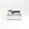 A modern, metallic couch from Project 213A a European design house launched in 2021, boasts a shiny silver finish and angular design.