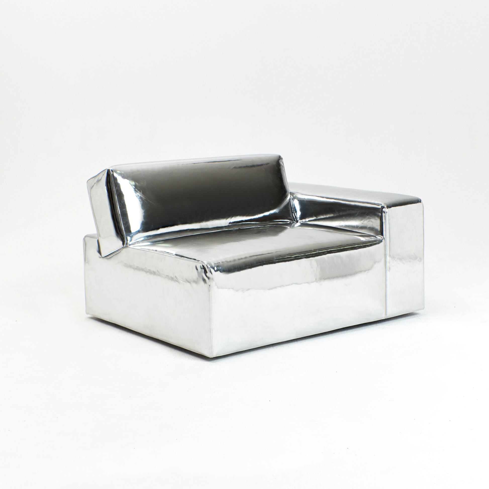 A modern, metallic couch from Project 213A a European design house launched in 2021, boasts a shiny silver finish and angular design.