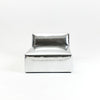 A modern, metallic couch from Project 213A a European design house launched in 2021, boasts a shiny silver finish and angular design.