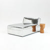 A modern, metallic couch from Project 213A a European design house launched in 2021, boasts a shiny silver finish and angular design.