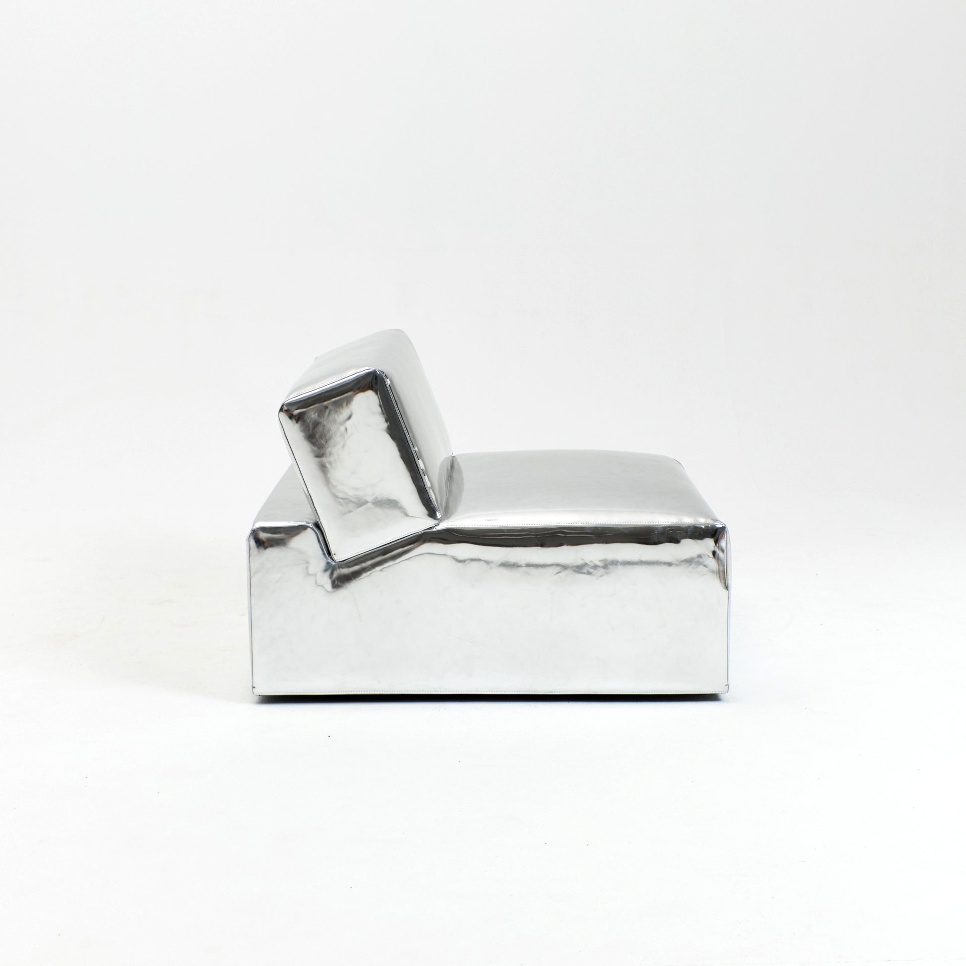 A modern, metallic couch from Project 213A a European design house launched in 2021, boasts a shiny silver finish and angular design.