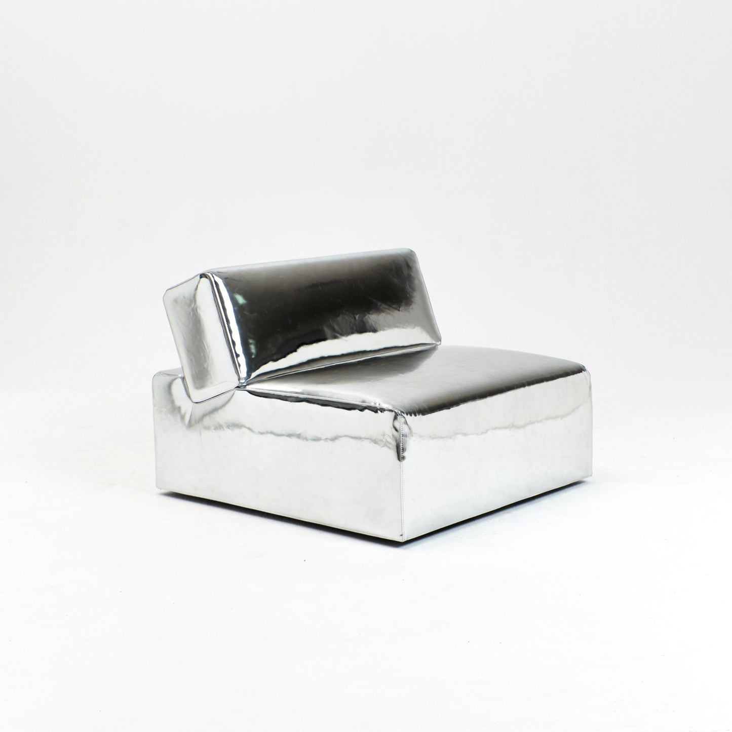 A modern, metallic couch from Project 213A a European design house launched in 2021, boasts a shiny silver finish and angular design.