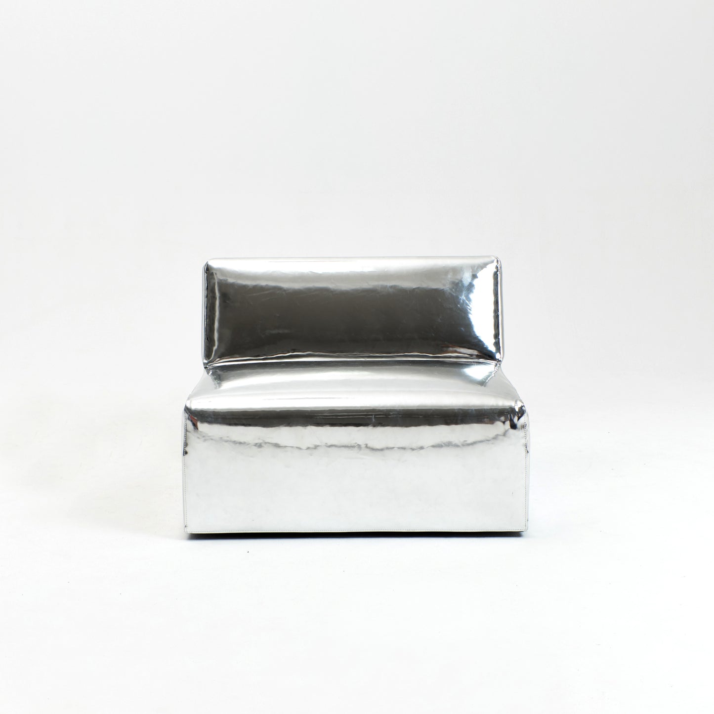 A modern, metallic couch from Project 213A a European design house launched in 2021, boasts a shiny silver finish and angular design.