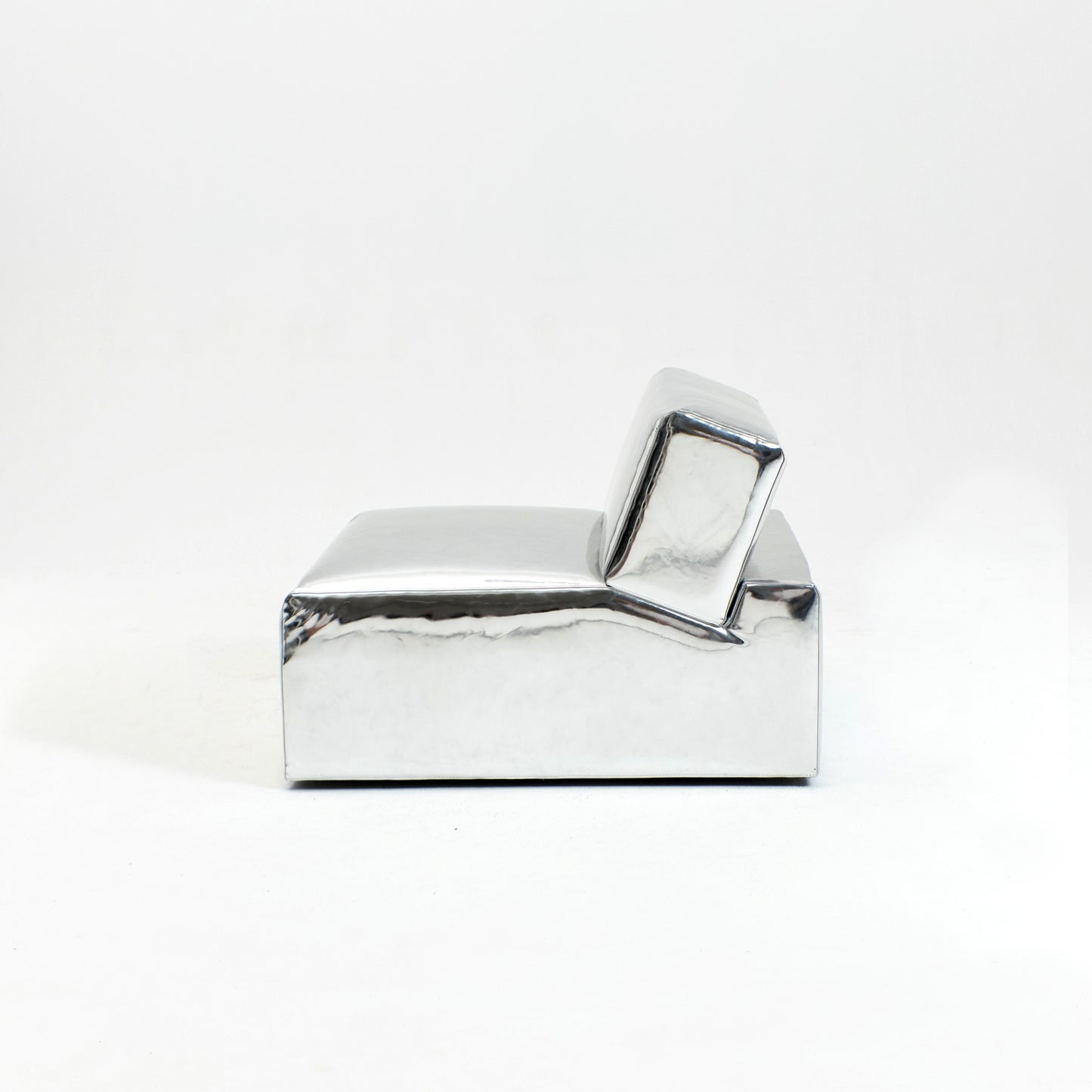 A modern, metallic couch from Project 213A a European design house launched in 2021, boasts a shiny silver finish and angular design.