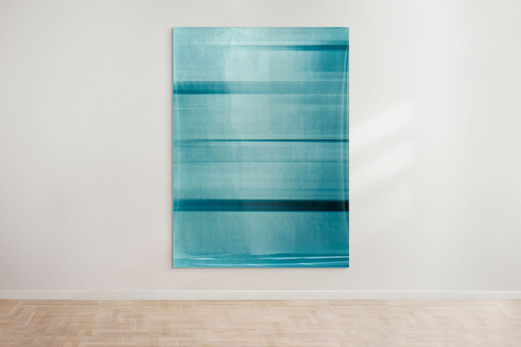 An abstract artwork by a graduate artist in the UK features horizontal bands of blue. The colors blend and blur, creating a dynamic, textured effect. Displayed with small metal clips at the corners, this piece is part of the graduate artworks for sale by The Graduate Gallery.