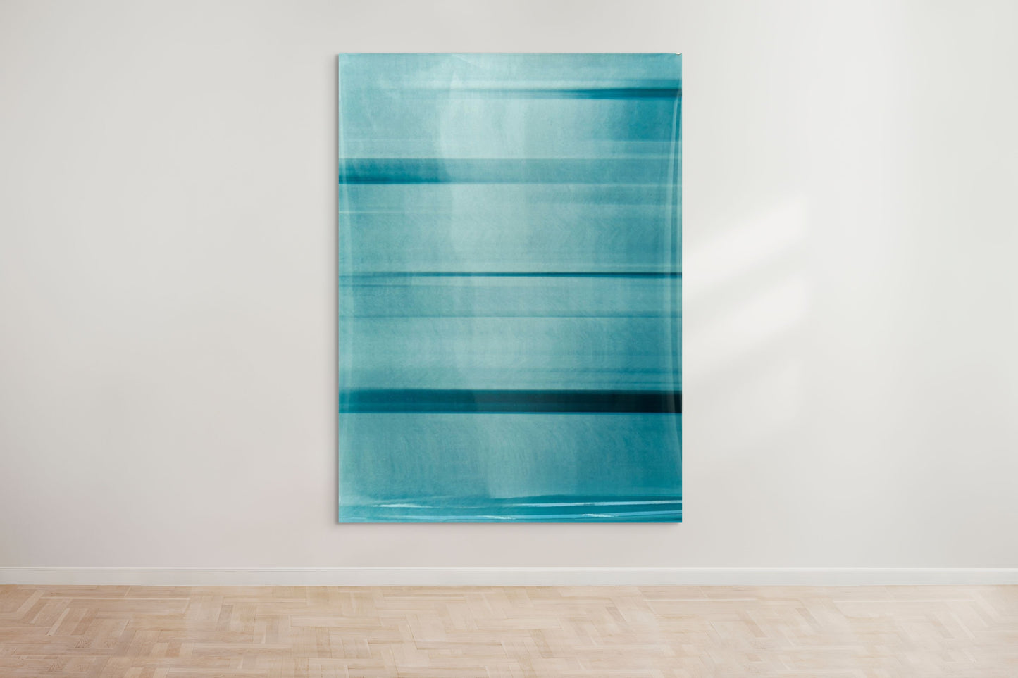 An abstract artwork by a graduate artist in the UK features horizontal bands of blue. The colors blend and blur, creating a dynamic, textured effect. Displayed with small metal clips at the corners, this piece is part of the graduate artworks for sale by The Graduate Gallery.