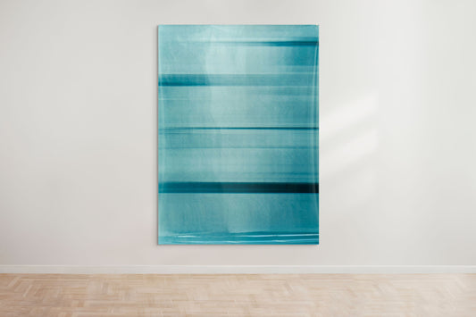 An abstract artwork by a graduate artist in the UK features horizontal bands of blue. The colors blend and blur, creating a dynamic, textured effect. Displayed with small metal clips at the corners, this piece is part of the graduate artworks for sale by The Graduate Gallery.