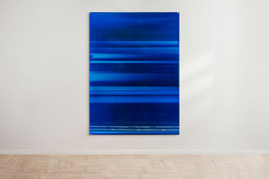 An abstract artwork by a graduate artist in the UK features horizontal bands of blue. The colors blend and blur, creating a dynamic, textured effect. Displayed with small metal clips at the corners, this piece is part of the graduate artworks for sale by The Graduate Gallery.