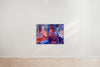 A colorful painting created by a talented graduate artist in the UK features abstract figures, including a central one wrapped in dark cloth. Other figures are near mirrors and a wooden structure, set against a blue background with hints of orange and red. This stunning piece is available for sale at The Graduate Gallery.