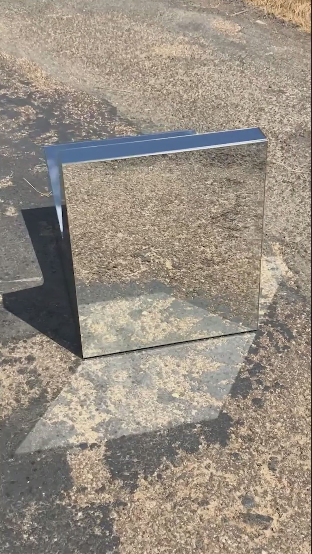 Discover a modern chair with a minimalist design, featuring a reflective mirror surface. Its angular shape creates a geometric aesthetic, set against a plain white background. This stunning piece of furniture is available for sale by The Graduate Gallery.