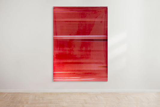 A large abstract artwork by a graduate artist in the UK features a mix of bold and faded red horizontal stripes. The piece has a glossy finish, mounted on a white wall. This graduate artwork, available for sale at The Graduate Gallery, has layered shades creating depth and movement.