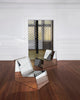 Discover a modern chair with a minimalist design, featuring a reflective mirror surface. Its angular shape creates a geometric aesthetic, set against a plain white background. This stunning piece of furniture is available for sale by The Graduate Gallery.