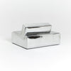 A modern, metallic couch from Project 213A a European design house launched in 2021, boasts a shiny silver finish and angular design. With its rectangular backrest, this piece of furniture stands elegantly against a plain white background.