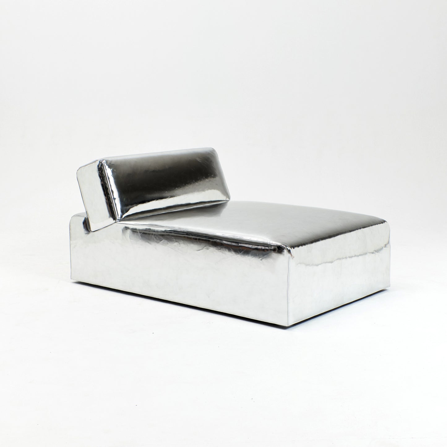 A modern, metallic couch from Project 213A a European design house launched in 2021, boasts a shiny silver finish and angular design. 