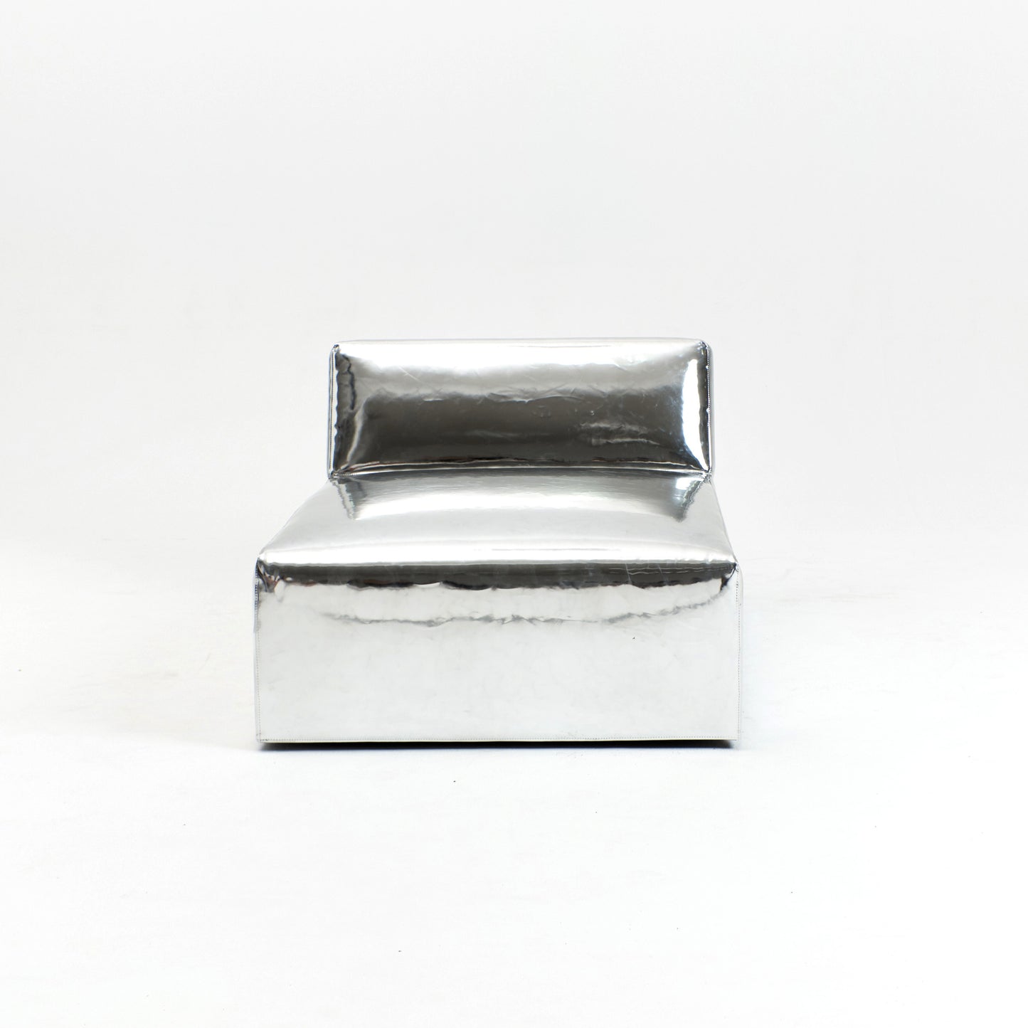 A modern, metallic couch from Project 213A a European design house launched in 2021, boasts a shiny silver finish and angular design. 