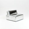 A modern, metallic couch from Project 213A a European design house launched in 2021, boasts a shiny silver finish and angular design. 