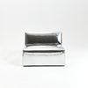 A modern, metallic couch from Project 213A a European design house launched in 2021, boasts a shiny silver finish and angular design. 