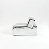 A modern, metallic couch from Project 213A a European design house launched in 2021, boasts a shiny silver finish and angular design. 