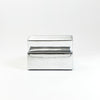 A modern, metallic couch from Project 213A a European design house launched in 2021, boasts a shiny silver finish and angular design. 